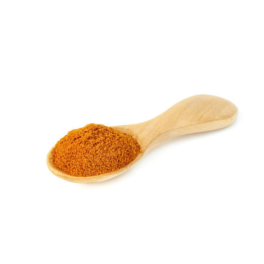 Ground mace sprinkled on wooden spoon